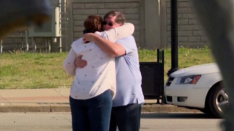 PHOTO: People embrace at Old National Bank in Louisville, Ky., on April 10, 2023.