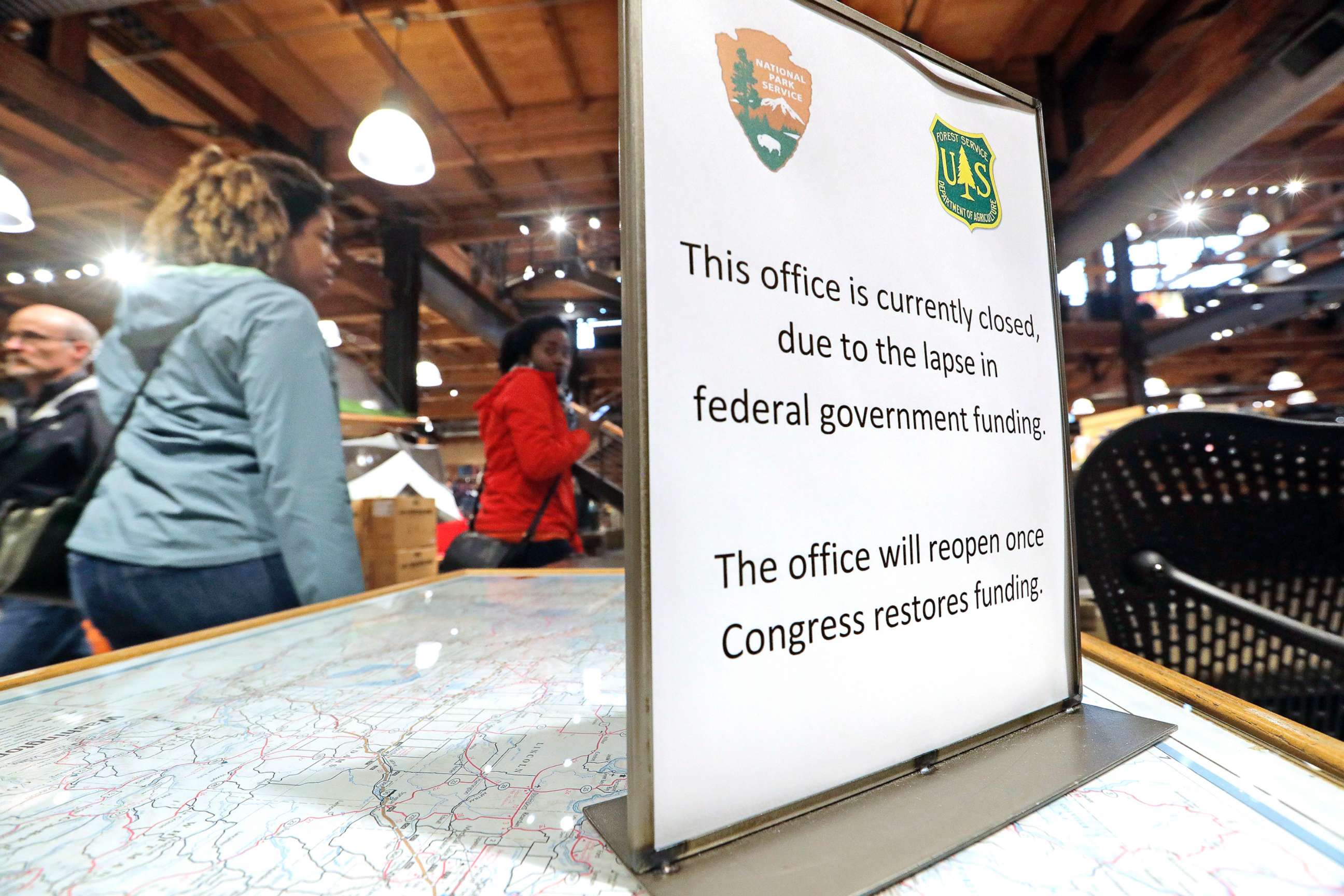 PHOTO: REI Co-op customers walk past an unstaffed ranger station kiosk, closed as part of the federal government shutdown, inside the flagship store in Seattle, Dec. 26, 2018.