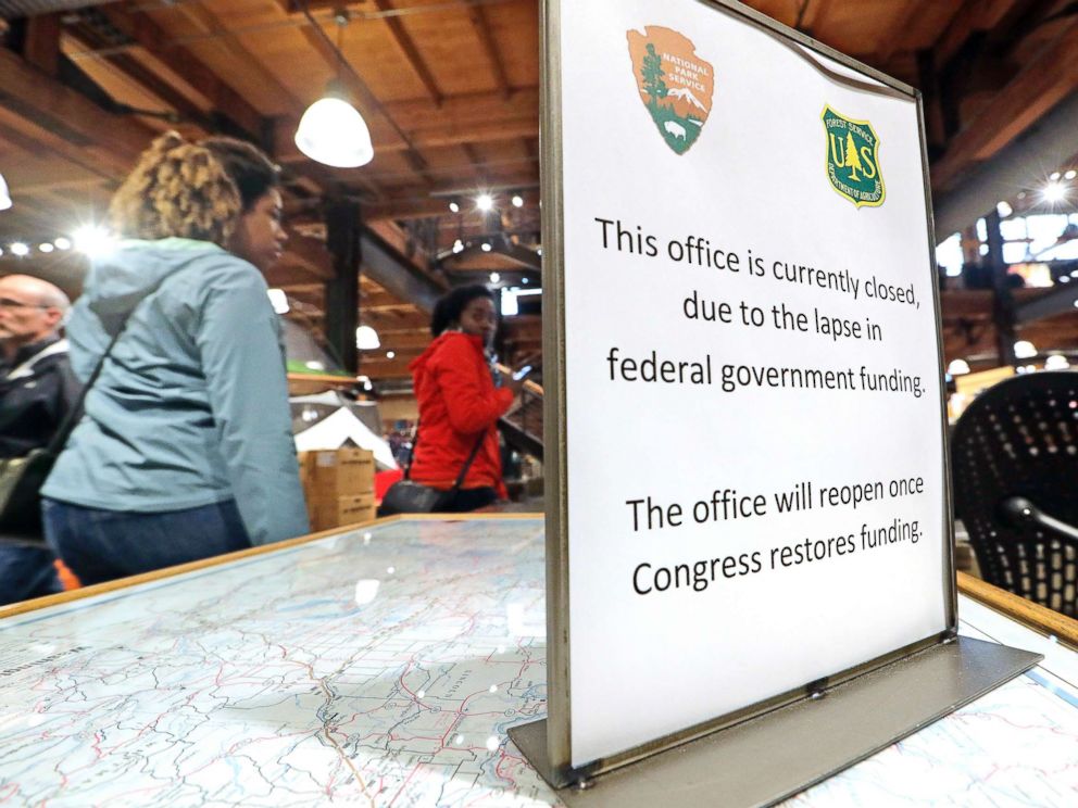 PHOTO: REI Co-op customers walk past an unstaffed ranger station kiosk, closed as part of the federal government shutdown, inside the flagship store in Seattle, Dec. 26, 2018.