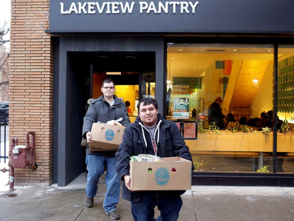 PHOTO: TSA worker John Salinas, right, and his fiancee Ryan Farmer leave the Lakeview Pantry after receiving food in Chicago, Jan. 14, 2019.