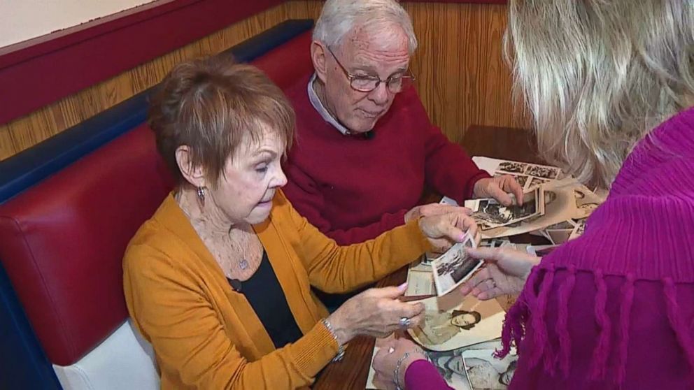 PHOTO: Connie Rusk looks through family photos with her brother, Dennis Blackstone, when the two were reunited after 70 years of separation in Dallas, Texas.