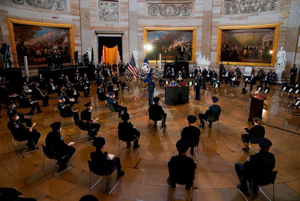 PHOTO: US Capitol police officers and other guests are seated as they pay their respects at the remains of US Capitol Police Officer Brian Sicknick as he lays in honor in the Rotunda of the Capitol building on Feb. 3, 2021, in Washington.