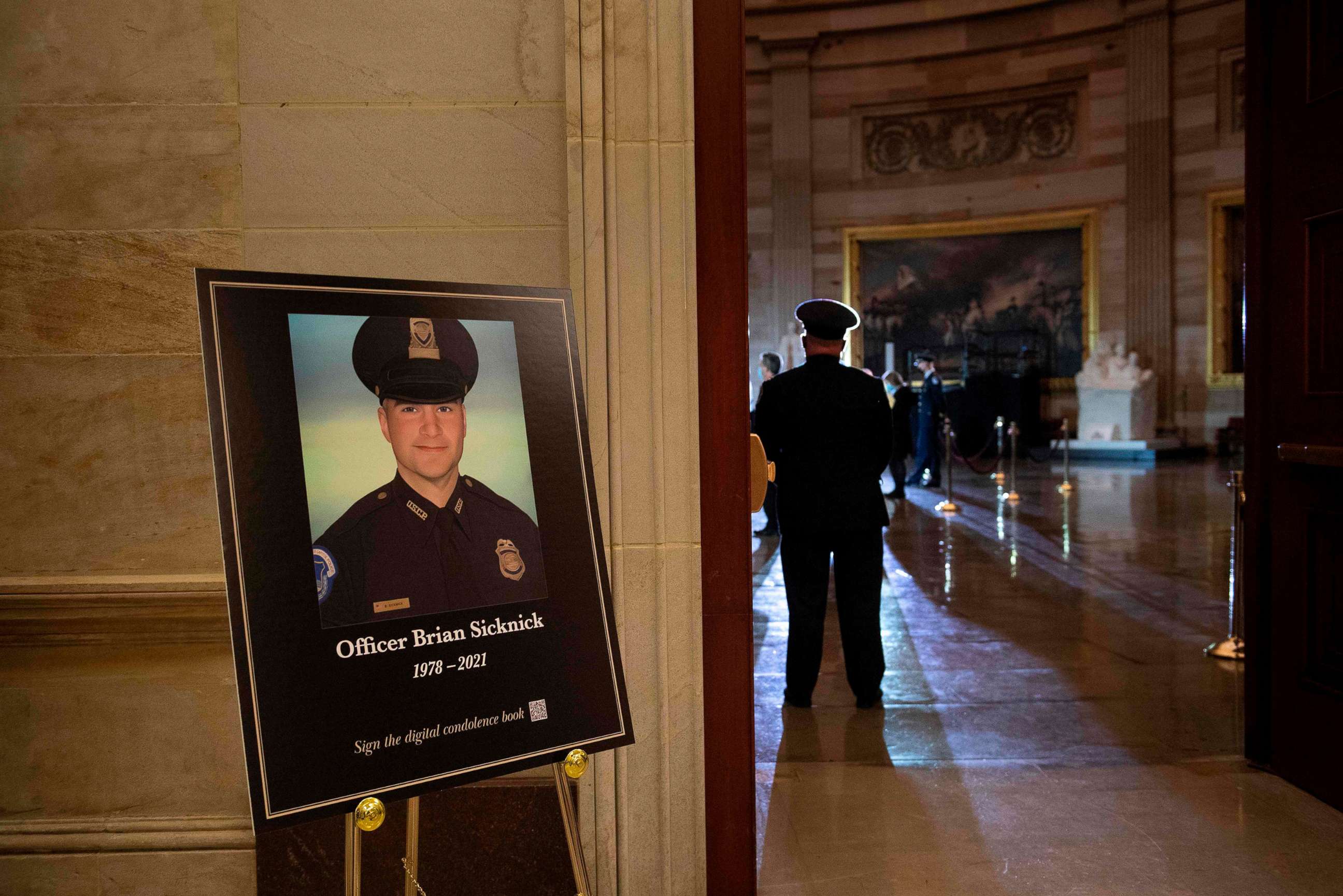 PHOTO: A photo of the fallen Capitol Police officer Brian Sicknick is posted outside the Rotunda wait as his remains on Feb. 2, 2021, in Washington.
