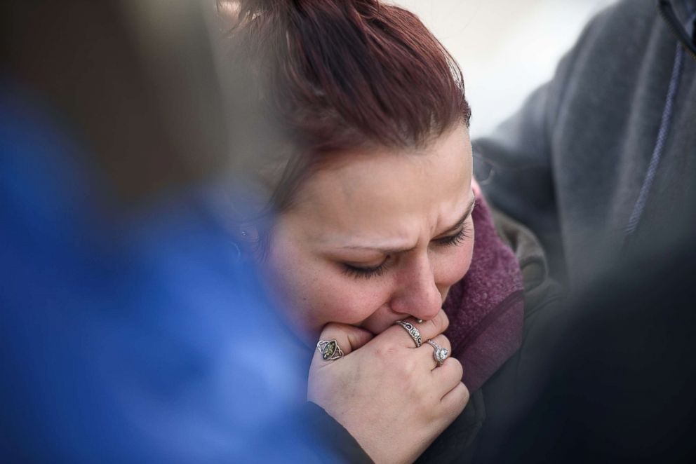 PHOTO: Sierra Kolarik, the sister of Chelsie Cline, one of the victims in a mass shooting at Ed's Car Wash, is comforted, Jan. 28, 2018, in Melcroft, Pa.