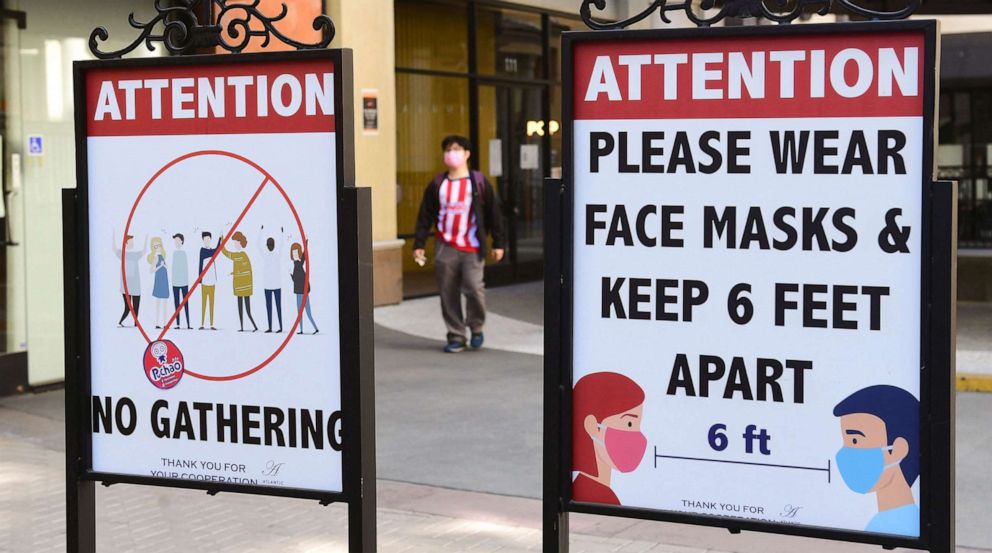 PHOTO: Signs reminding people to practice social distancing and wearing face masks stand at a mall in Monterey Park, Calif., June 14, 2021.