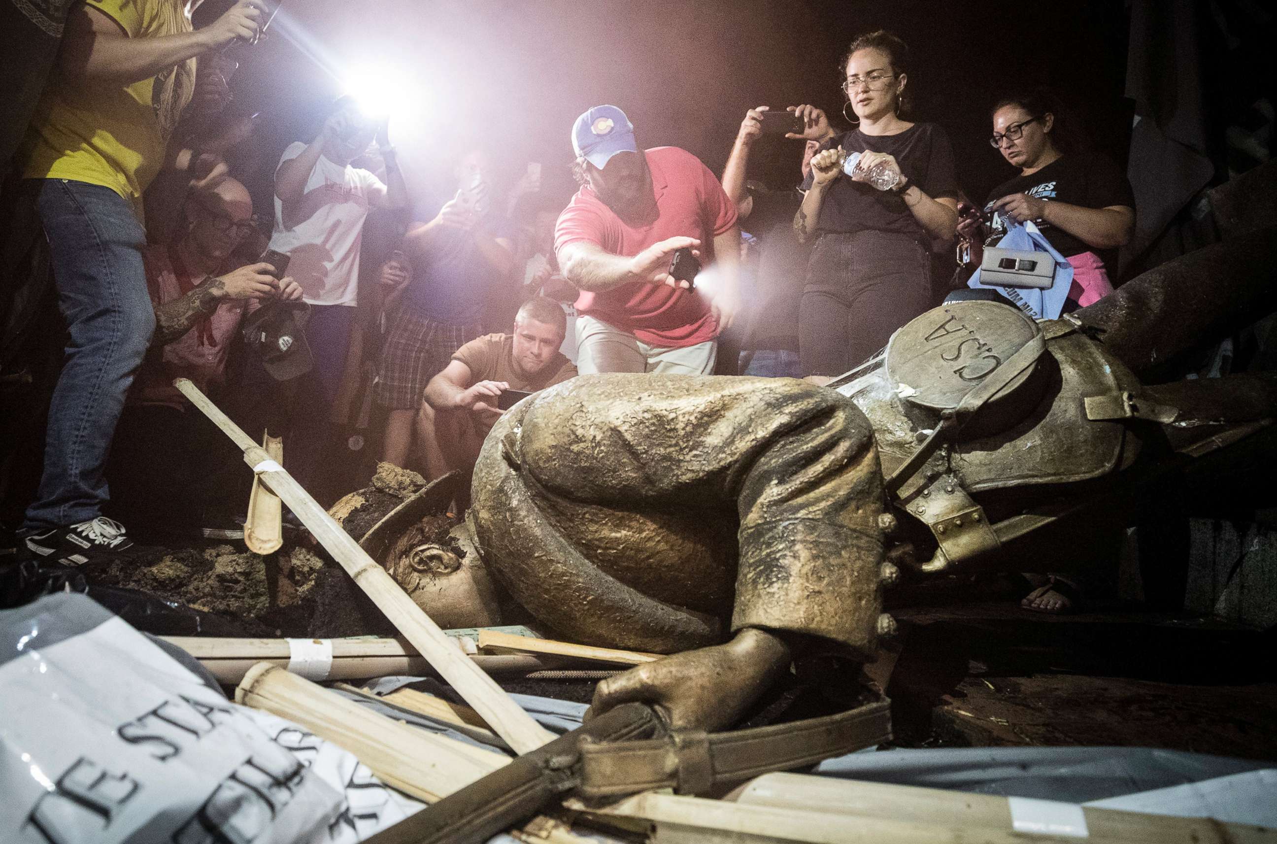 PHOTO: Demonstrators and spectators gather around a toppled Confederate statue known as Silent Sam, Aug. 20, 2018 at UNC-Chapel Hill, N.C