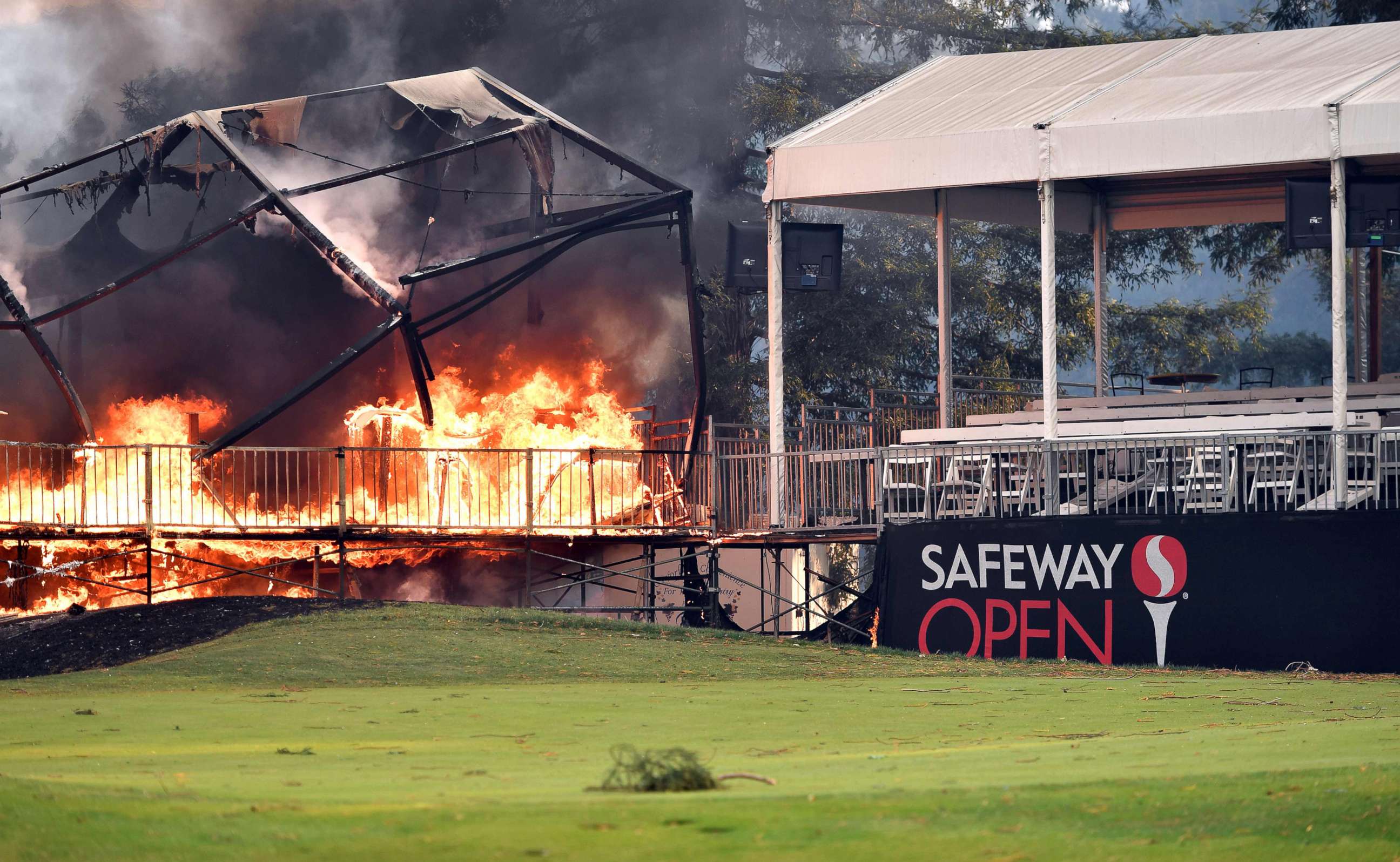 PHOTO: A tent structure built for the 2017 Safeway Open burns on a golf course at the Silverado Resort and Spa in Napa, Calif., Oct. 9, 2017, as multiple wind-driven fires continue to whip through the region. 