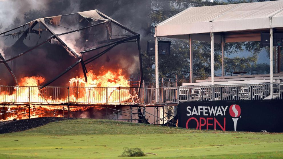 PHOTO: A tent structure built for the 2017 Safeway Open burns on a golf course at the Silverado Resort and Spa in Napa, Calif., Oct. 9, 2017, as multiple wind-driven fires continue to whip through the region. 