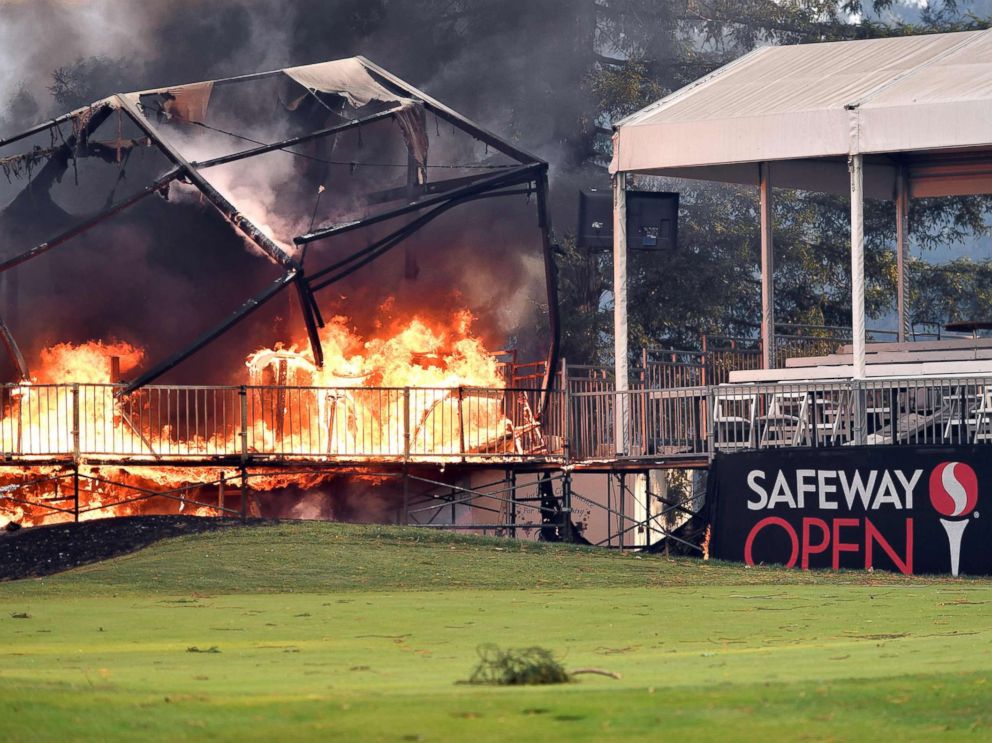 PHOTO: A tent structure built for the 2017 Safeway Open burns on a golf course at the Silverado Resort and Spa in Napa, Calif., Oct. 9, 2017, as multiple wind-driven fires continue to whip through the region.