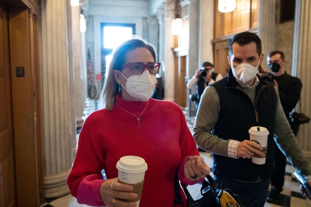 PHOTO: Sen. Kyrsten Sinema walks to the Senate Chamber for debate on voting rights legislation at the U.S. Capitol, Jan. 19, 2022, in Washington, D.C.