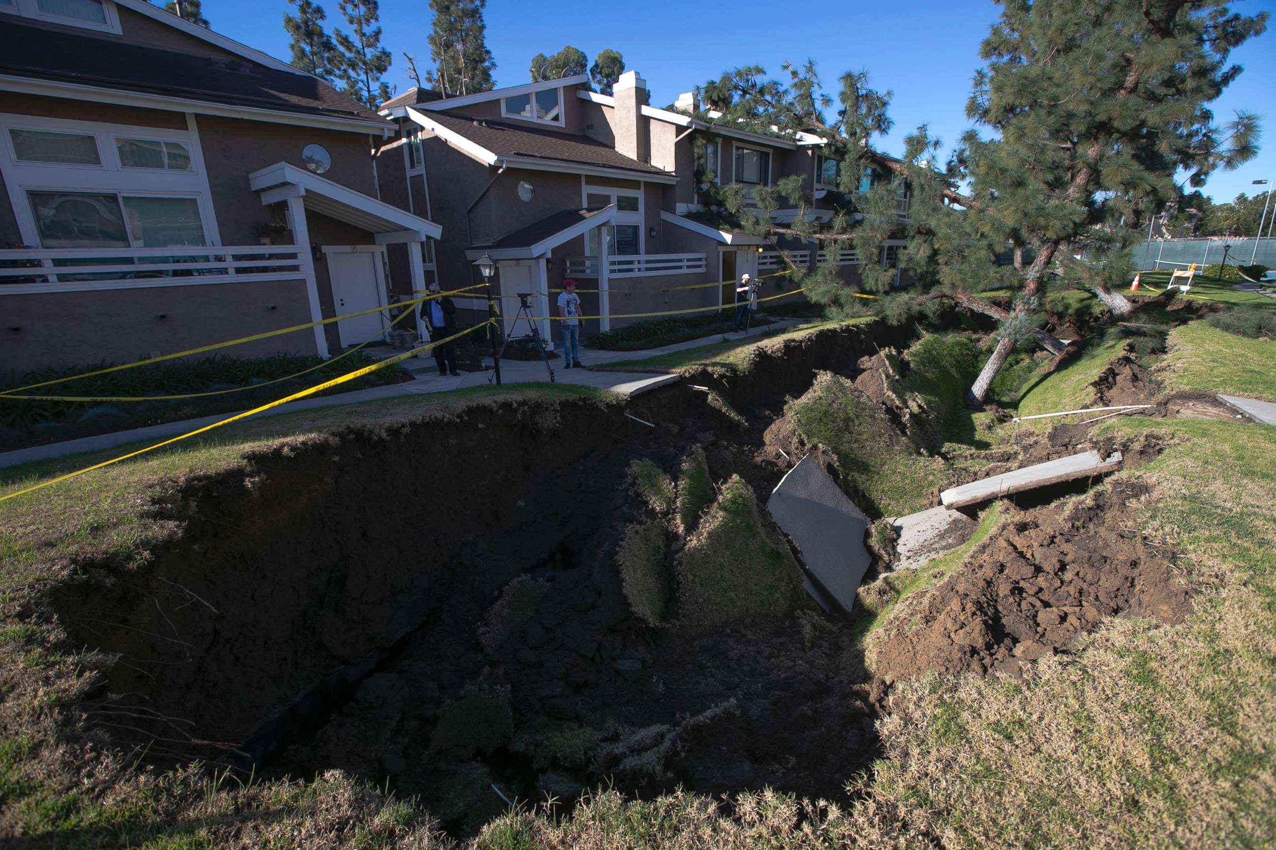 PHOTO: A sinkhole is seen in a condominium complex, Jan. 24, 2019, in La Habra, Calif. The hole is estimated to be about 80 feet  long and 20 feet wide.