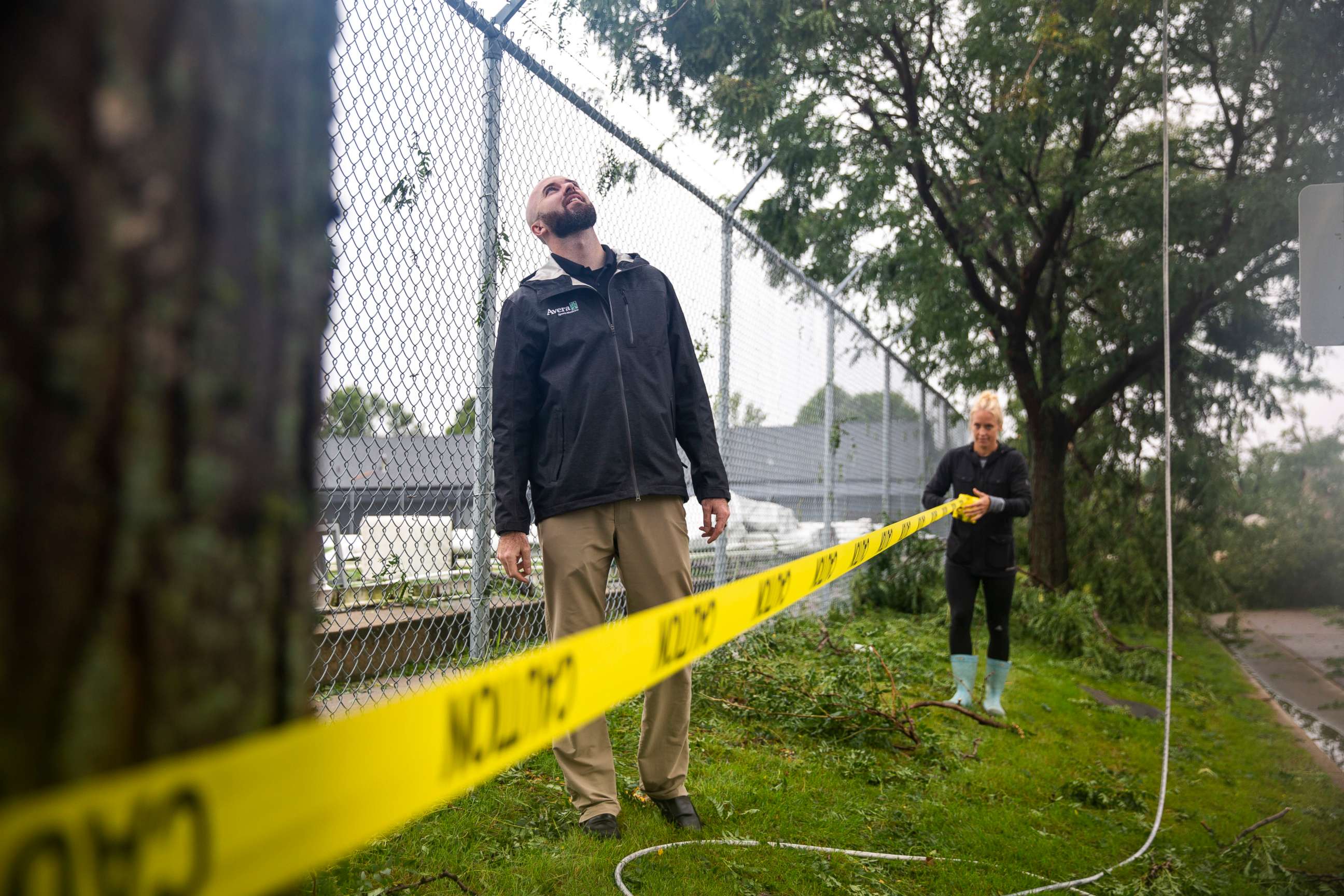 PHOTO: Whitnee Fester puts up caution tape outside of the Avera dome after a devastating tornado hit in Sioux Falls, S.D., Sept. 11, 2019.