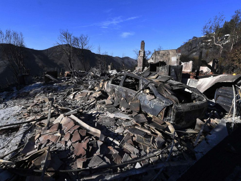 PHOTO: A burnt out house and car are seen after the Skirball wildfire swept through the exclusive enclave of Bel Air, Calif., Dec. 7, 2017.
