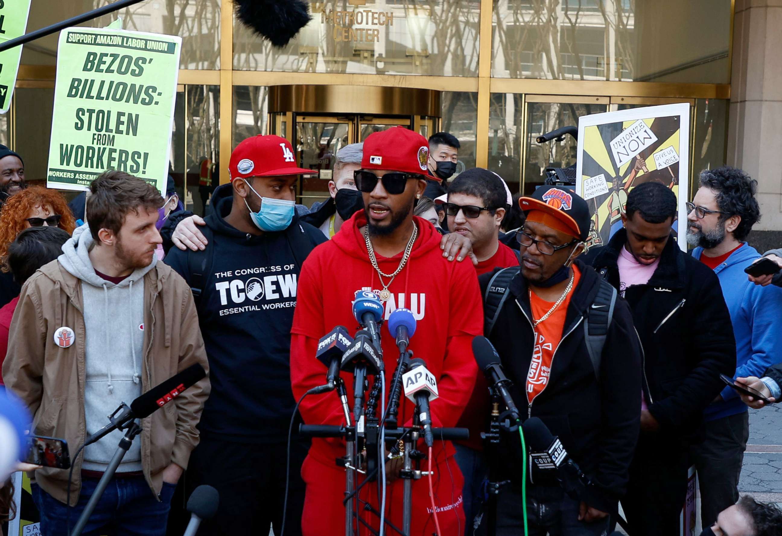 PHOTO: Staten Island-based Amazon.com Inc distribution center union organizer Chris Smalls (C) addresses members of the media after their victory results regarding the vote to unionize in Brooklyn, N.Y., April 1, 2022.