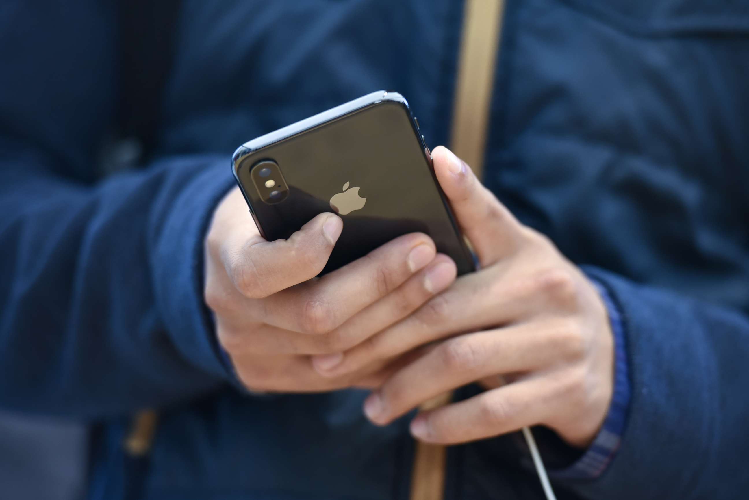 PHOTO: A customer views an Apple Inc. iPhone X smartphone during the sales launch at a store in San Francisco, Nov. 3, 2017. 