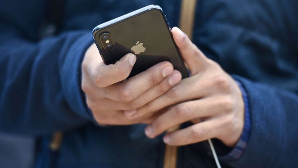 A customer views an Apple Inc. iPhone X smartphone during the sales launch at a store in San Francisco, Nov. 3, 2017.