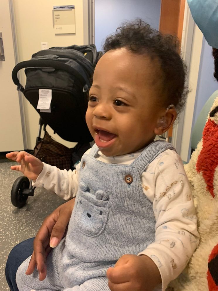 PHOTO: 1-year-old Maison McMillian, of Richmond, sat on his mother Lauryn Webb’s lap as he was fitted for hearing aids at VCU Children’s Hospital. 