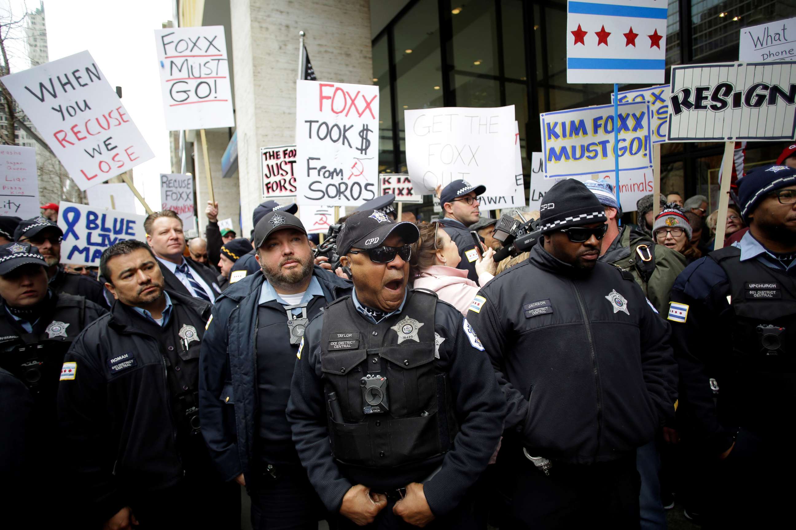 PHOTO:Chicago police officers stand in front of Fraternal Order of Police supporters protesting the handling of the Jussie Smollett case by the State's Attorney Kim Foxx in Chicago, April 1, 2019.  