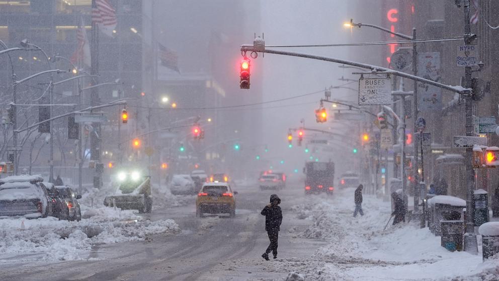 PHOTO: A pedestrian crosses Sixth Avenue during a snow storm, Feb. 23, 2026, in New York. 