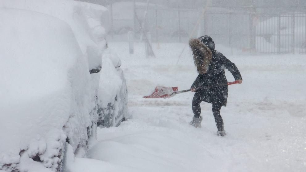 PHOTO: A woman shovels her car out of the snow in Hoboken, NJ, Feb. 23, 2026.