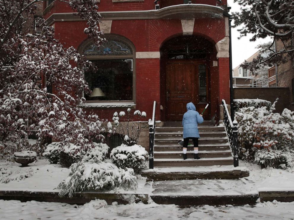 PHOTO:A resident clears snow from her steps in the Wicker Park neighborhood, Nov. 11, 2019 in Chicago.