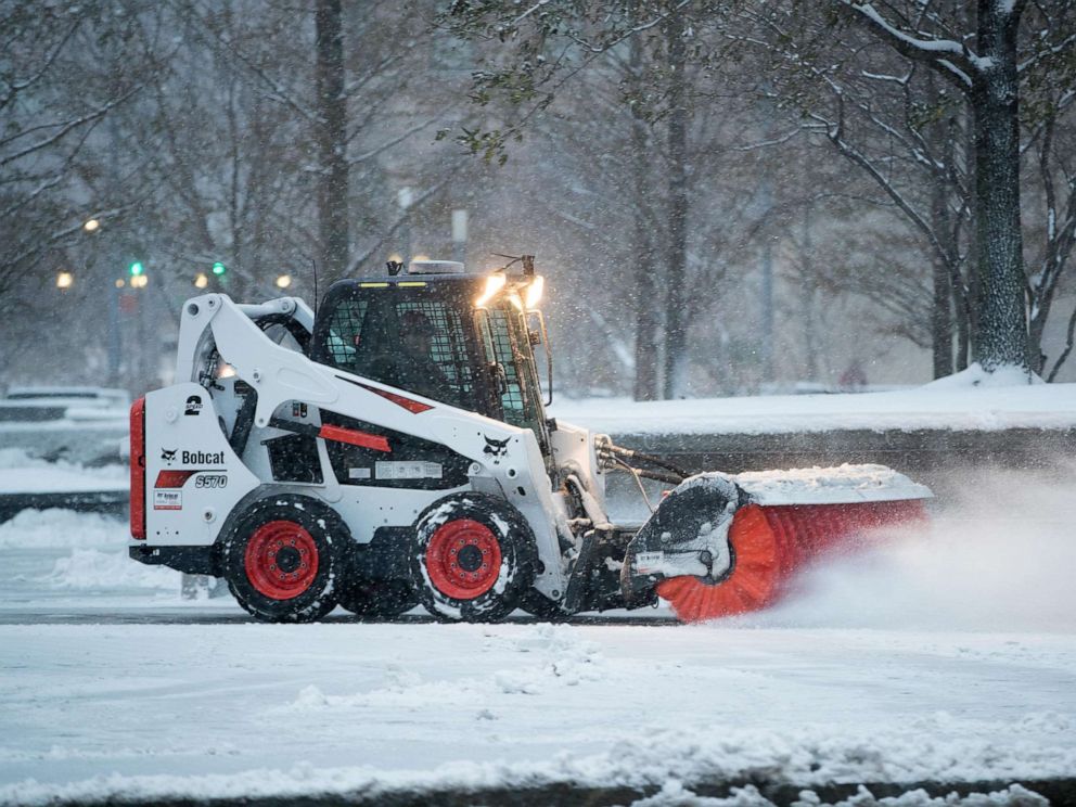 PHOTO: A vehicle works to clear snow from a sidewalk near South Station as the first winter storm of the season impacts the region, Dec. 3, 2019 in Boston.