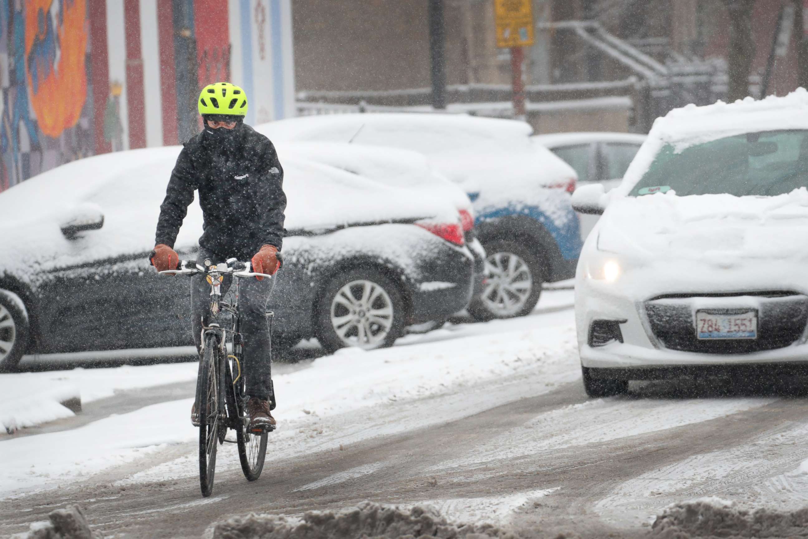 PHOTO: A cyclist navigates a snow-covered street in the Humboldt Park neighborhood, Nov. 11, 2019, in Chicago.