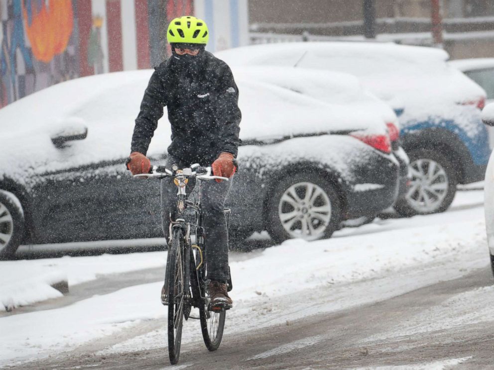 PHOTO: A cyclist navigates a snow-covered street in the Humboldt Park neighborhood, Nov. 11, 2019, in Chicago.