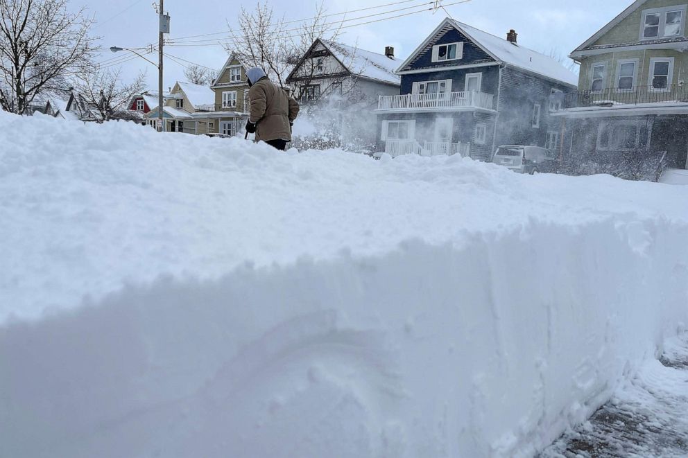 PHOTO: Martin Haslinger clears snow from the front of his home, Sunday, Dec. 25, 2022, in Buffalo, N.Y.
