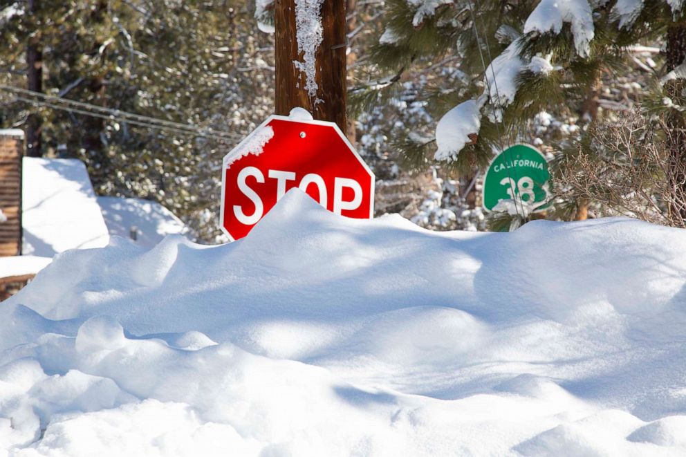 PHOTO: A stop sign almost completely covered in snow in Big Bear City, Calif., on March 2, 2023.