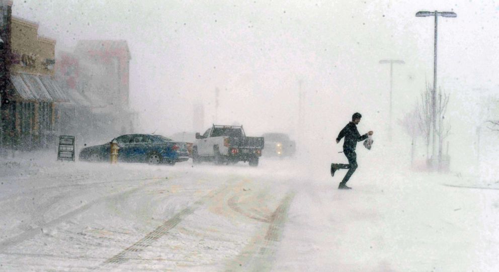 PHOTO: A man sprints to his car as he leaves the Sprouts grocery store on North Gate Blvd. in Colorado Springs, Colo., March 13, 2019.  