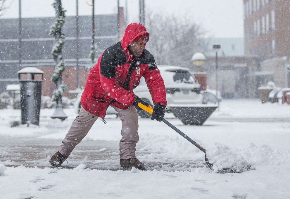 PHOTO: Terrance Pates, of Downtown South Bend, clears a sidewalk along Michigan Avenue on  Nov. 26, 2018, in South Bend, Ind.