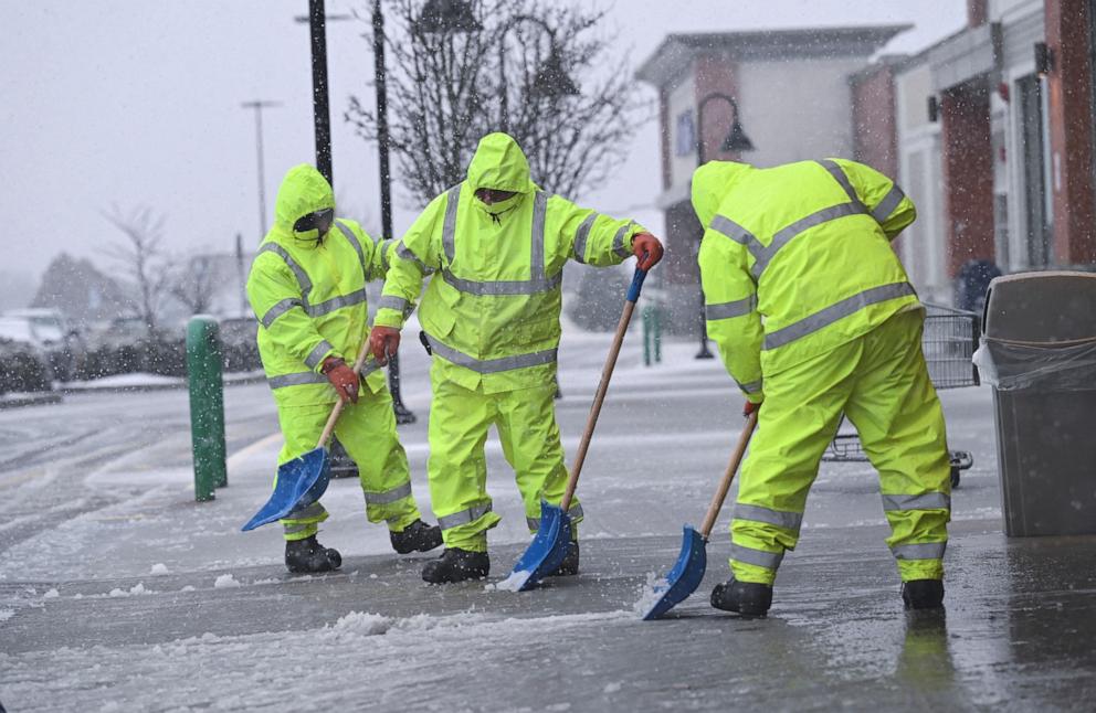 PHOTO: Workers clear snow at the entrance to the Market Basket supermarket  during a fast-moving winter storm which was expected to hit the  Northeast, in Plymouth, Mass.,  Feb. 13, 2024.  