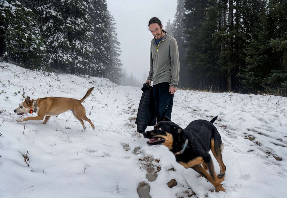 PHOTO: Chris Dugan, from Santa Fe, plays with his dogs at the Ski Santa Fe, on Oct. 17, 2022, in Sante Fe, N.M.