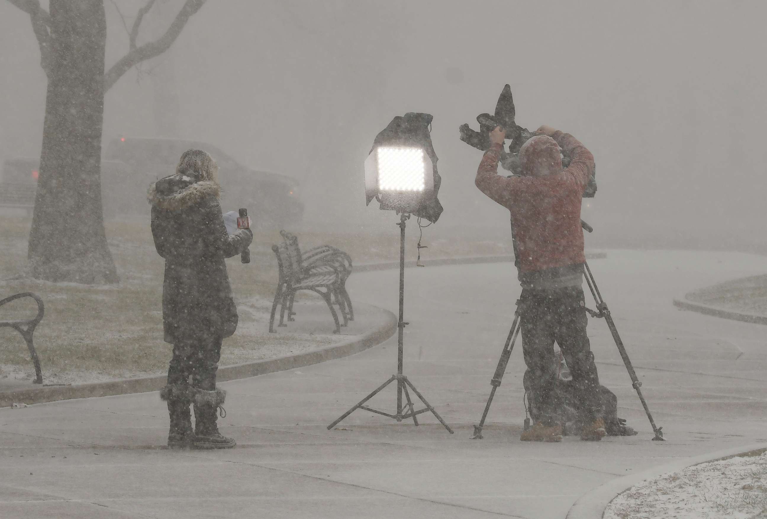PHOTO: Reporters produce a television report in a snow squall outside the New York state Capitol, Wednesday, Jan. 20, 2021, in Albany, N.Y. Joe Biden was inaugurated as President on Wednesday in Washington.