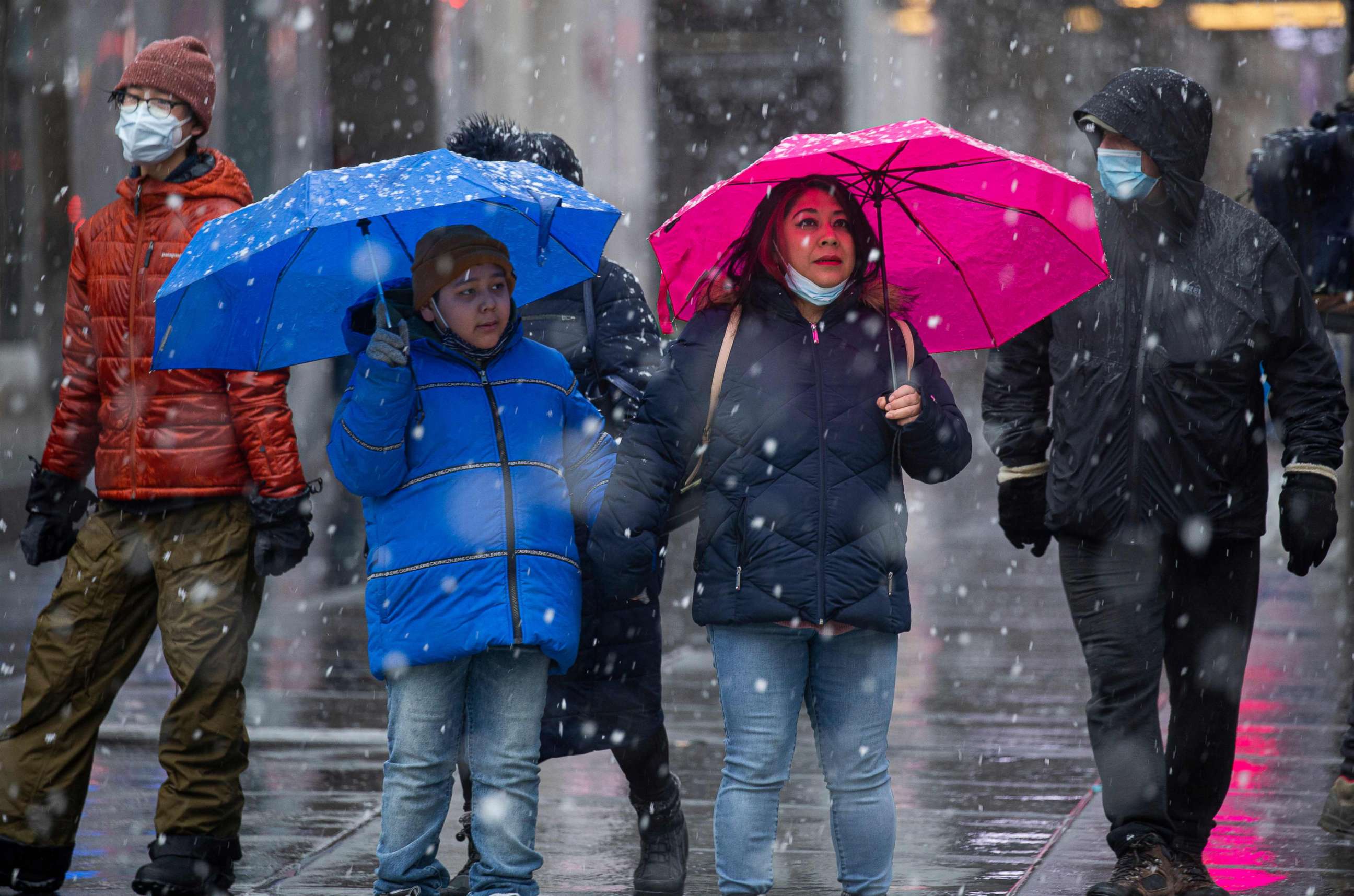 PHOTO: People walk as snow falls in New York City on February 7, 2021. 