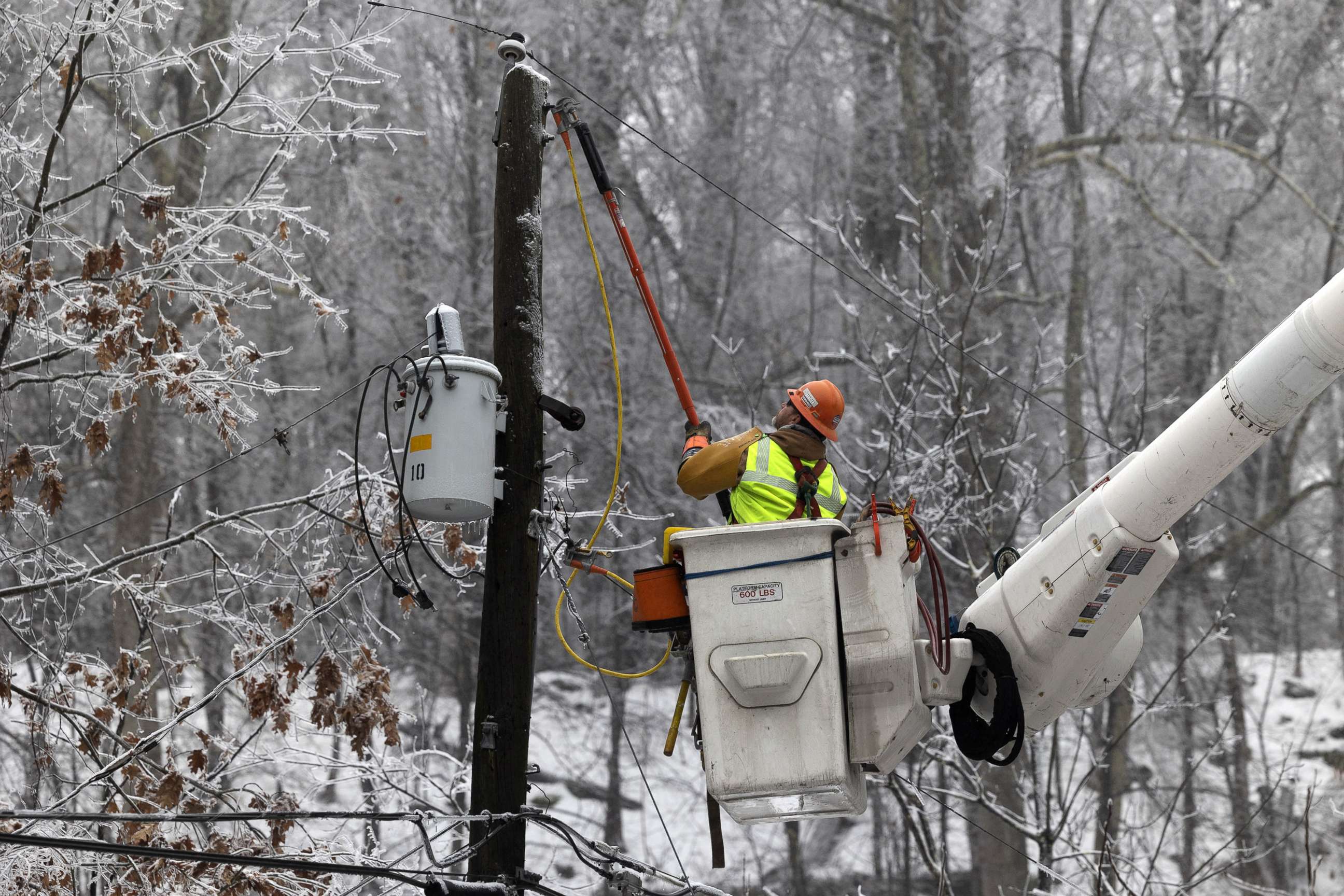 PHOTO: A worker fixes power lines following a winter storm near High Falls, N.Y., Feb. 7, 2022.