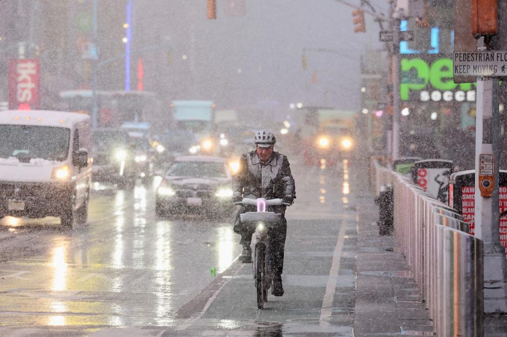 PHOTO: A person rides on a bicycle through wind and snow during a winter storm in New York City, Feb. 13, 2024.