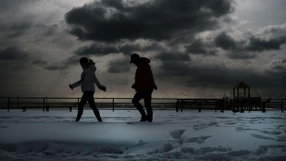 PHOTO: People walk through the snow at Coney Island on Feb. 3, 2021 in New York City. 