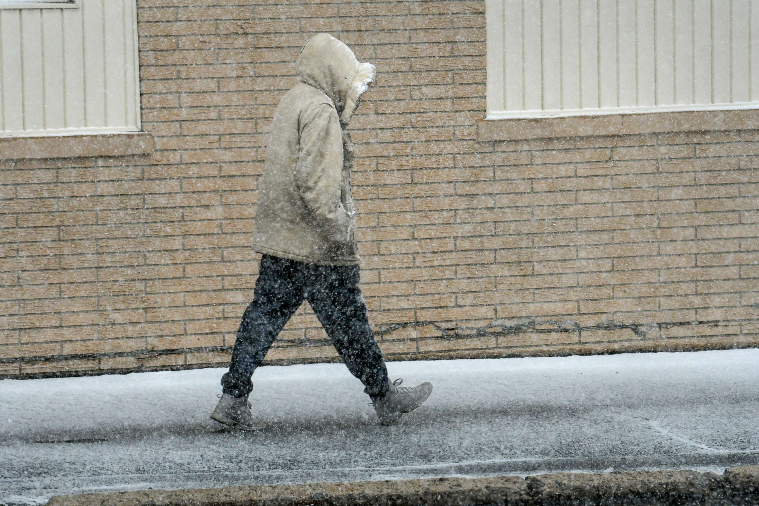 PHOTO: A person walks as snow falls in Frackville, Pa., on Easter Sunday, April 17, 2022.