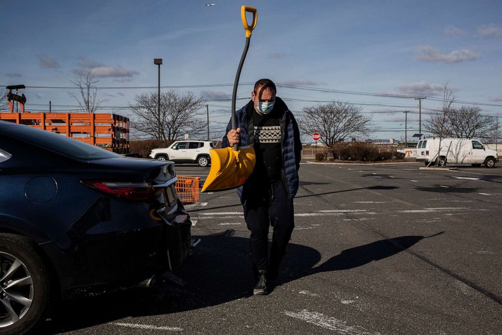 PHOTO: Rubi Koren with a new snow shovel at a Home Depot store in Jersey City, N.J., Dec. 15, 2020, as he prepares for a storm expected to bring snow. 