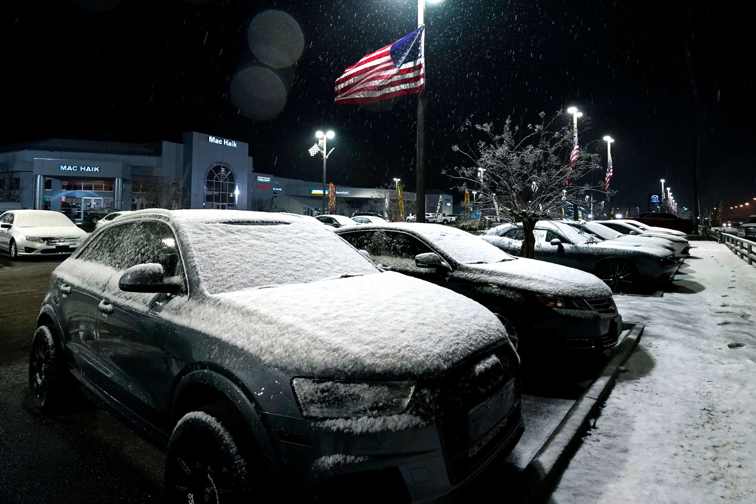 PHOTO: Snow and ice cover new automobiles at a dealership, Jan. 10, 2021, in Jackson, Miss. 