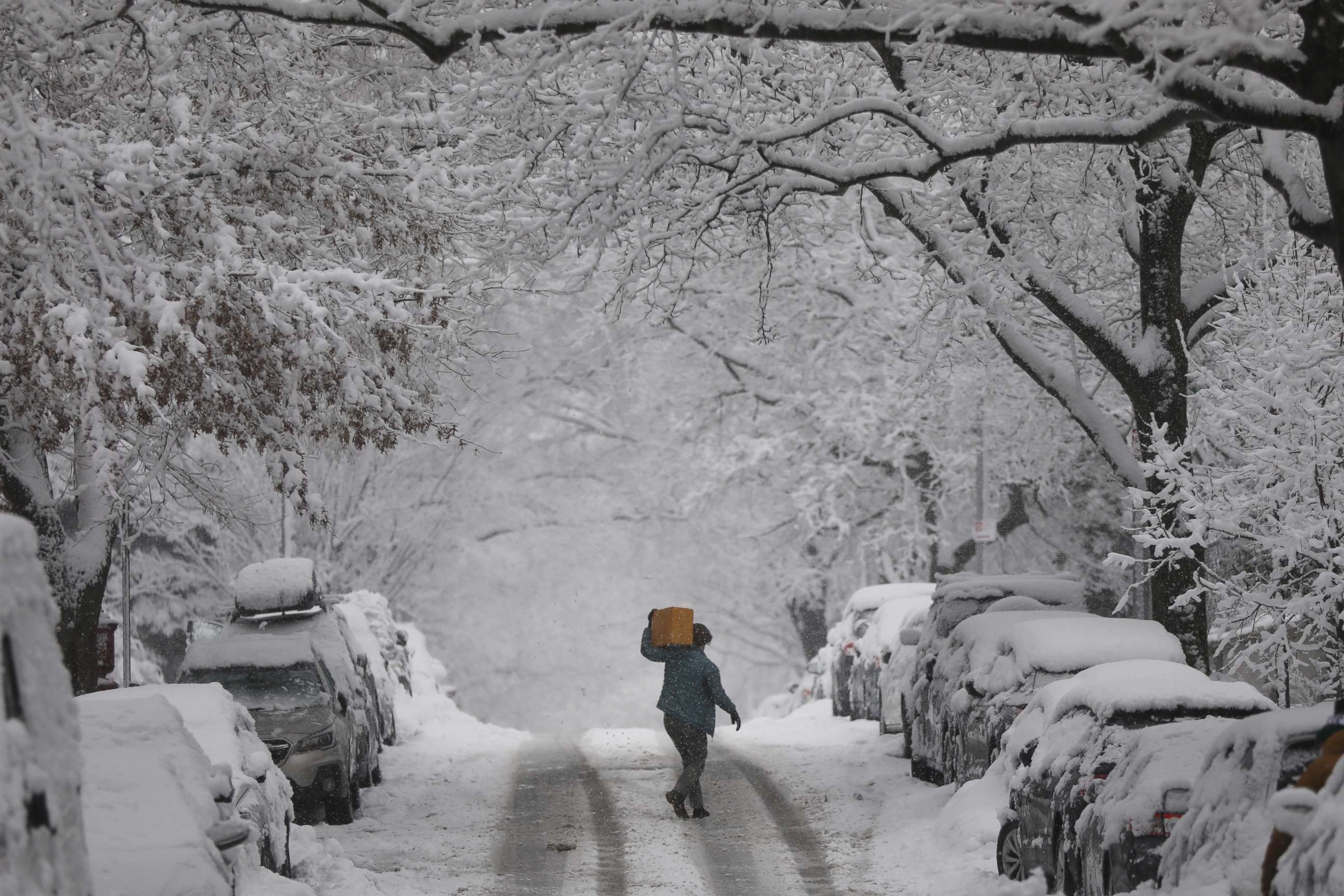 PHOTO:A person crosses the street during a snow storm on Feb. 7, 2021, in New York City. 