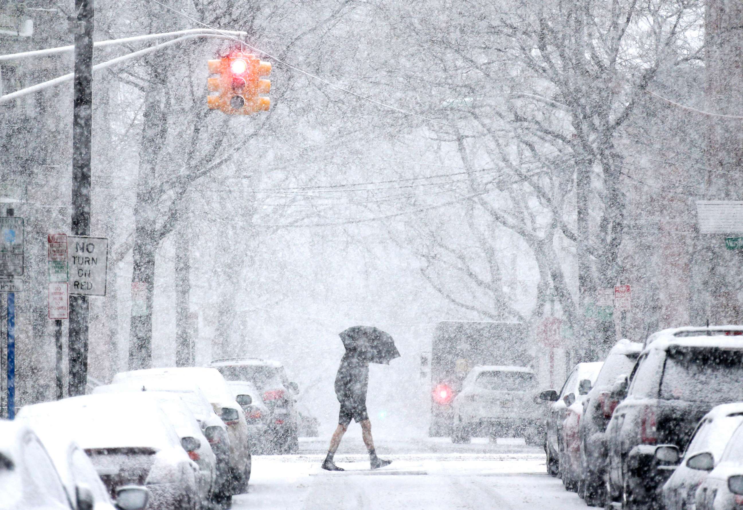 PHOTO: A man crosses the street through heavy snow in Hoboken, N.J., March 7, 2018. 