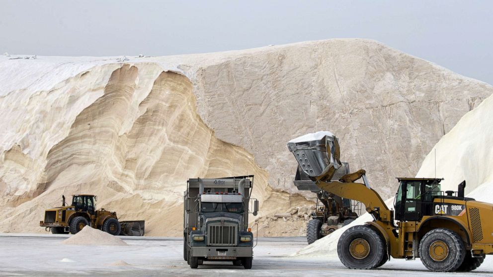 PHOTO: Large tractor trailer trucks are filled with road salt at Eastern Salt, for delivery to area towns as the region prepares for a major snowstorm, in Chelsea, Mass., Jan. 28, 2022.