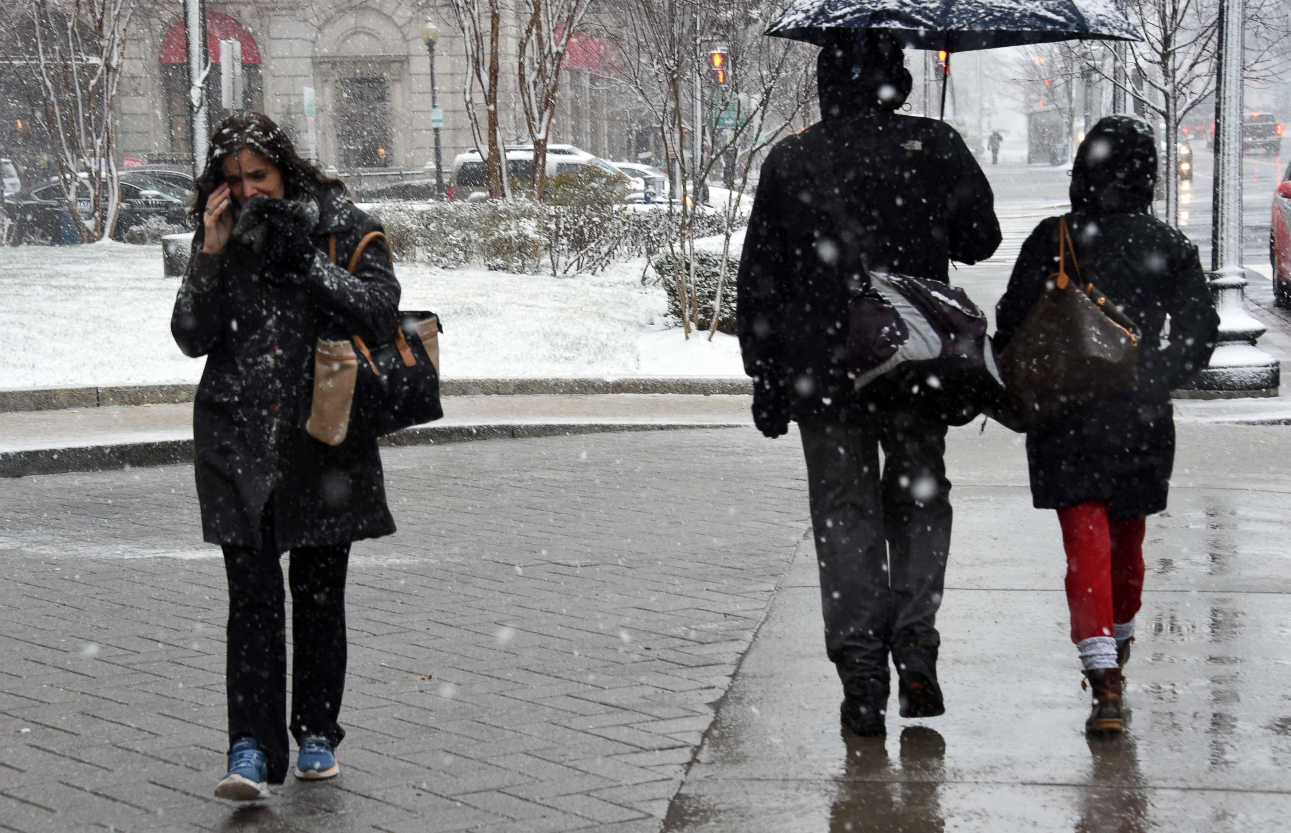 PHOTO: Pedestrians weather the latest storm to hit the U.S. east coast, March 21, 2018, in Washington, DC.
