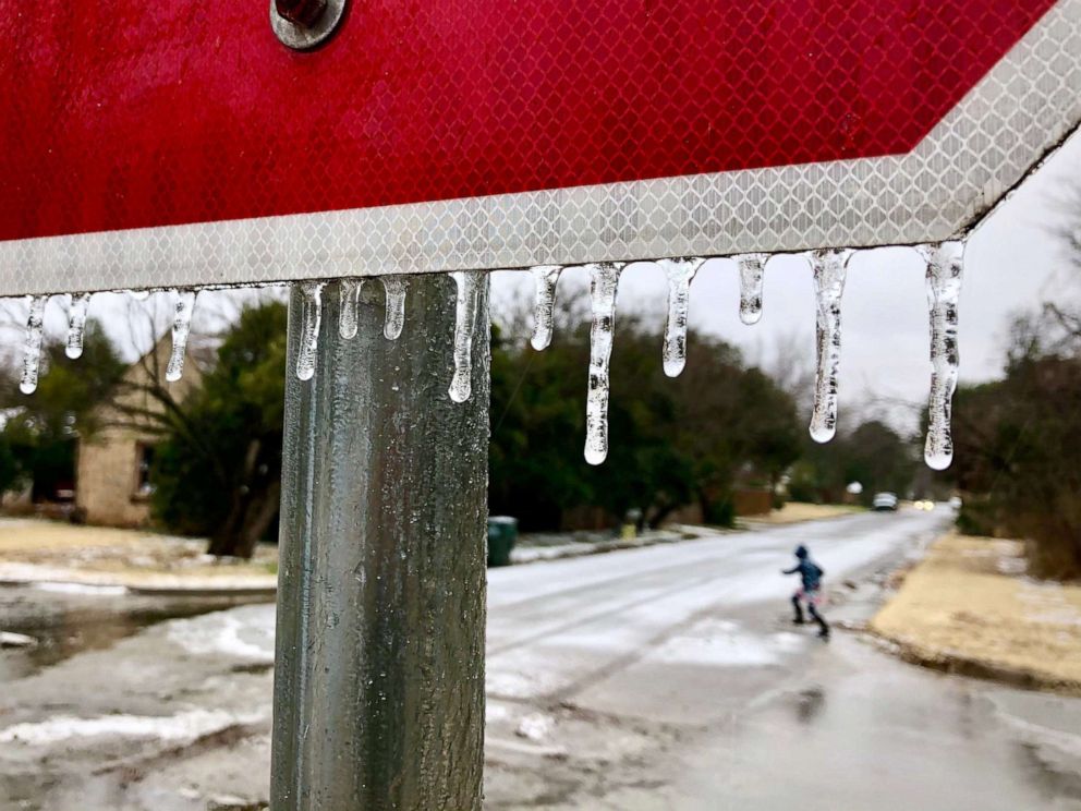 PHOTO: Ice drips from a stop sign as sleet begins to fall in Abilene, Texas, Dec. 31, 2020.