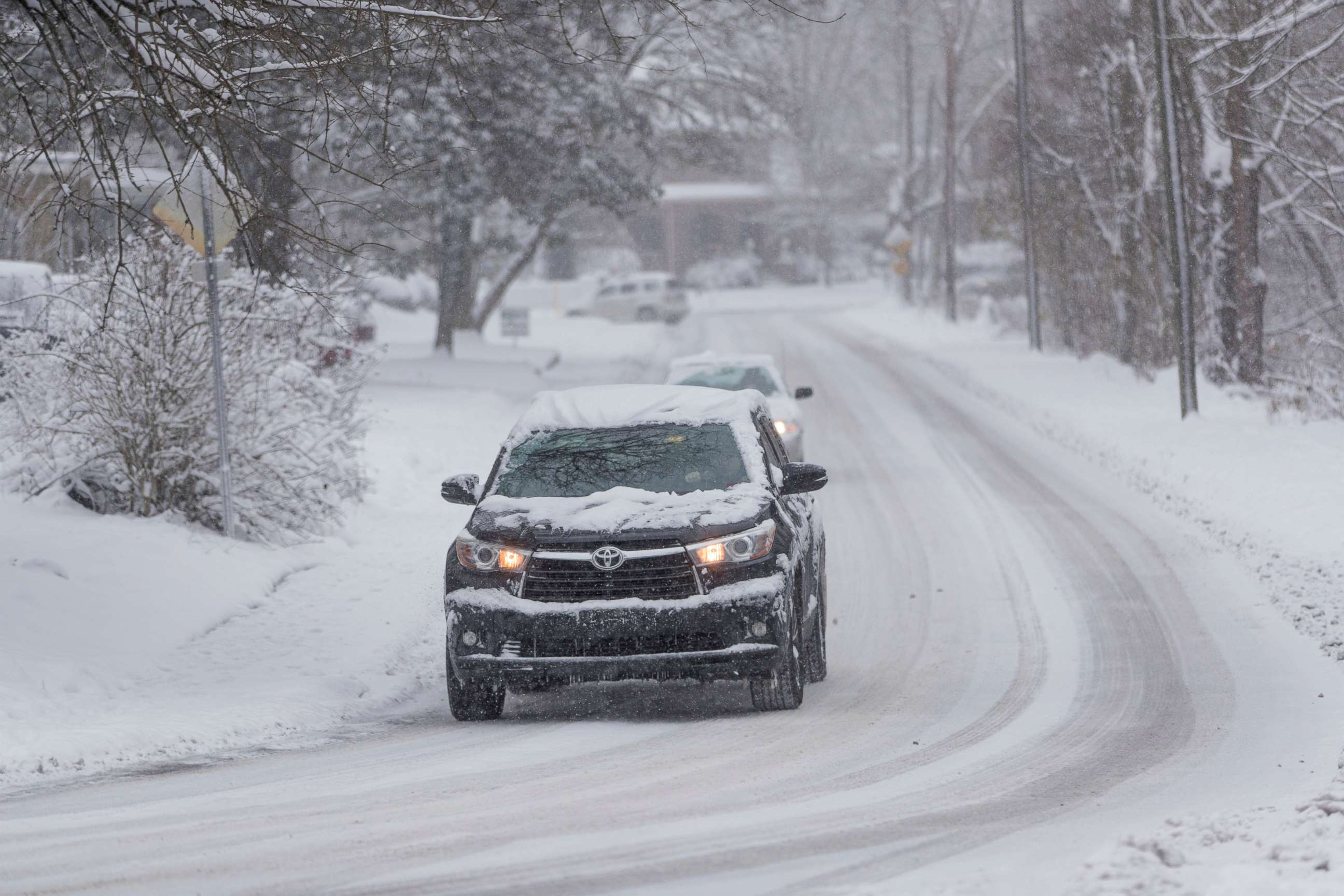 PHOTO: Vehicles travel across snow covered roads near Ritter Park on Friday, Dec. 25, 2020, in Huntington, W.Va.