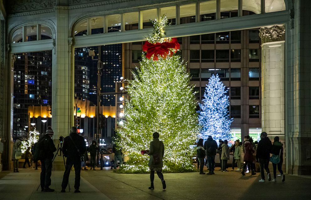 PHOTO: People gather around Christmas trees on Michigan Ave. in Chicago, Dec. 19, 2021.