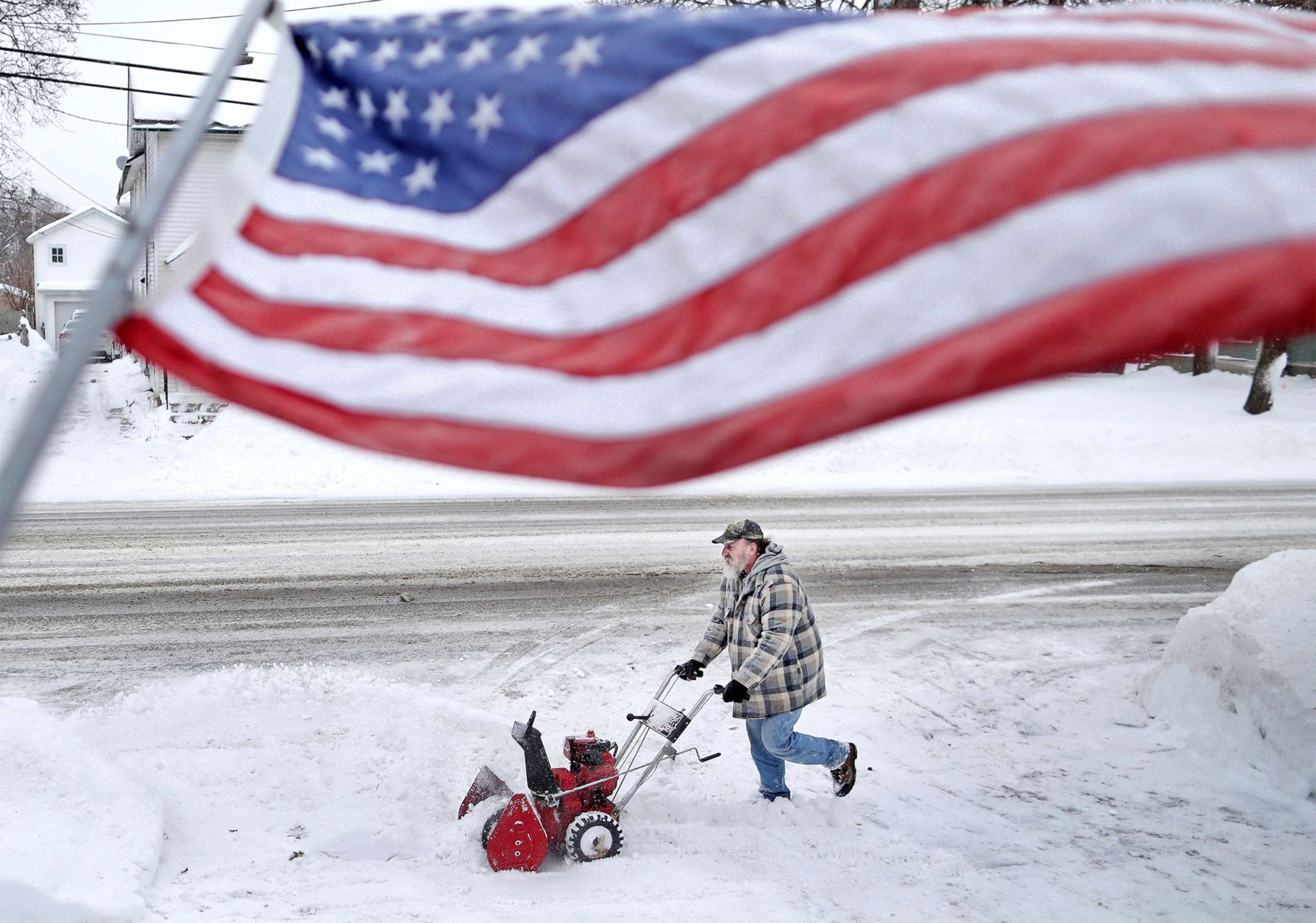 PHOTO: Jan White clears snow from his driveway, Jan. 28, 2019, following a winter snowstorm that made its way through Janesville, Wis.